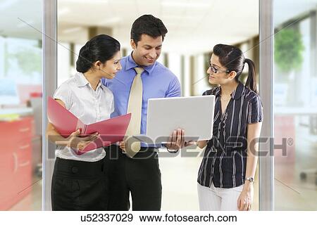 Businesspeople with laptops View Large Photo Image Stock Photo - Businesspeople with laptops . Fotosearch