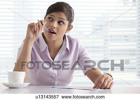 Businesswoman dreaming while preparing project View Large Photo Image Stock Photo - Businesswoman dreaming while preparing project . Fotosearch