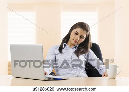 Stock Photograph - Businesswoman feeling lazy at work . Fotosearch