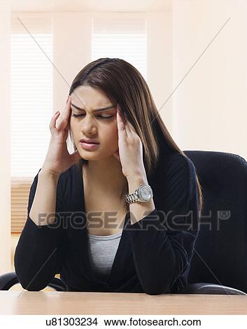 Businesswoman getting a headache View Large Photo Image Picture - Businesswoman getting a headache . Fotosearch