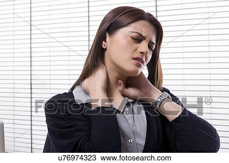 Businesswoman getting a neck ache View Large Photo Image Stock Image - Businesswoman getting a neck ache . Fotosearch