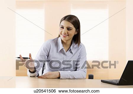 Stock Photograph - Businesswoman having a discussion . Fotosearch