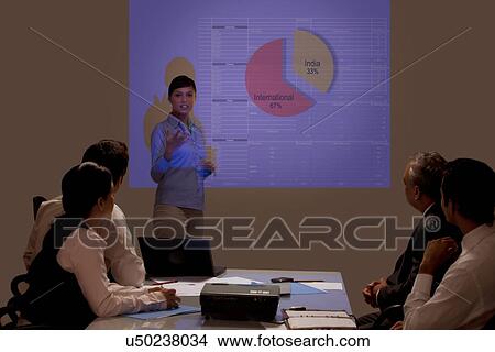 Picture - Businesswoman presenting on projection screen at seminar . Fotosearch