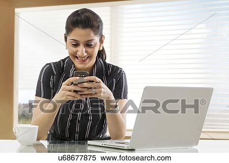 Businesswoman sending an sms View Large Photo Image Stock Photography - Businesswoman sending an sms . Fotosearch