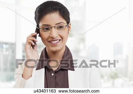 Businesswoman talking on a mobile phone View Large Photo Image Stock Image - Businesswoman talking on a mobile phone . Fotosearch