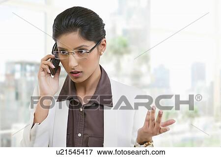 Businesswoman talking on a mobile phone View Large Photo Image Stock Photo - Businesswoman talking on a mobile phone . Fotosearch