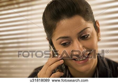 Stock Photo - Businesswoman talking on a mobile phone . Fotosearch