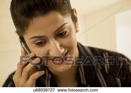 Stock Photo - Businesswoman talking on a mobile phone . Fotosearch