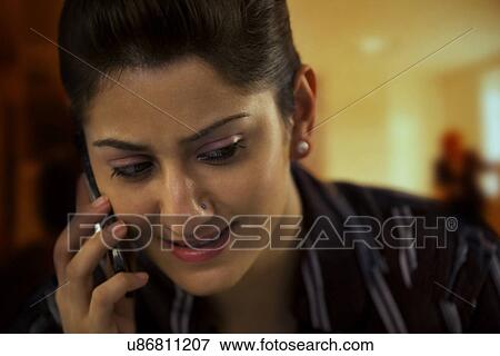 Stock Photo - Businesswoman talking on a mobile phone . Fotosearch