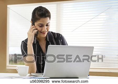 Businesswoman talking on a mobile phone View Large Photo Image Stock Photography - Businesswoman talking on a mobile phone . Fotosearch