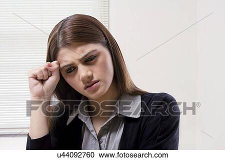 Stock Image - Businesswoman thinking hard . Fotosearch