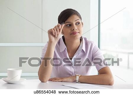 Stock Photo - Businesswoman thinking while preparing new project . Fotosearch