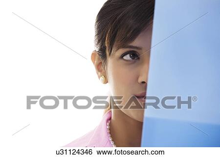 Businesswoman's face half hidden by a file View Large Photo Image Stock Photograph - Businesswoman's face half hidden by a file . Fotosearch
