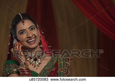 Close up happy young bride talking on cell phone View Large Photo Image Stock Image - Close up happy young bride talking on cell phone . Fotosearch