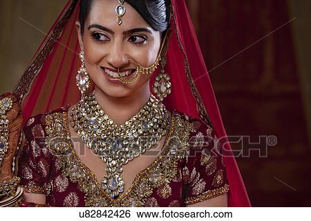 Close-up of a smiling bride looking away View Large Photo Image Stock Photograph - Close-up of a smiling bride looking away . Fotosearch