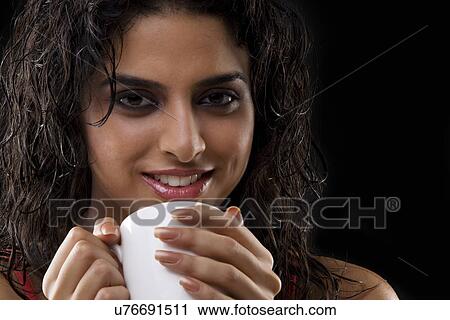 Close-up of a woman holding a mug View Large Photo Image Stock Image - Close-up of a woman holding a mug . Fotosearch