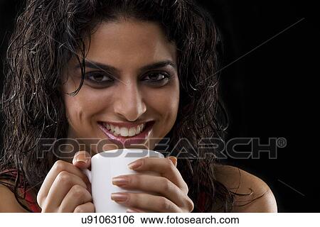 Close-up of a woman holding a mug View Large Photo Image Stock Photograph - Close-up of a woman holding a mug . Fotosearch