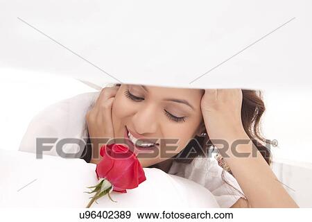 Stock Photo - Close-up of a woman with a rose. Fotosearch