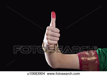 Picture - Close-up of a woman's hand making a Bharatanatyam gesture called Shikhara on black background. Fotosearch
