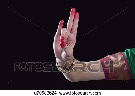 Close-up of a woman's hand making a Bharatanatyam gesture called Mayura on black background View Large Photo Image Picture - Close-up of a woman's hand making a Bharatanatyam gesture called Mayura on black background. Fotosearch