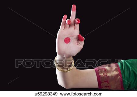 Stock Photo - Close-up of a woman's hand making a Bharatanatyam gesture called Shukatunda on black background. Fotosearch