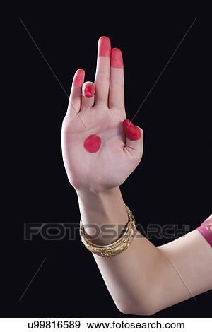 Stock Photo - Close-up of a woman's hand making a Bharatanatyam gesture called Tripataka on black background. Fotosearch
