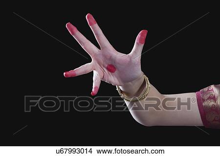 Picture - Close-up of a woman's hand making Bharatanatyam gesture called Alapadma on black background. Fotosearch
