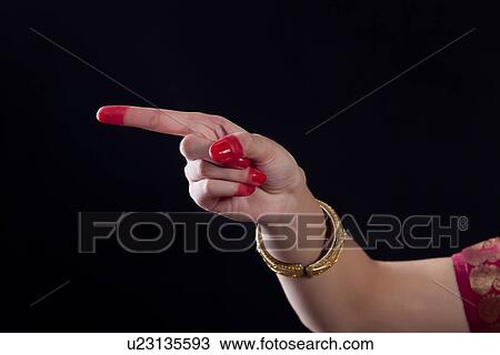 Close-up of a woman's hand making Bharatanatyam gesture called Suchi on black background View Large Photo Image Stock Image - Close-up of a woman's hand making Bharatanatyam gesture called Suchi on black background. Fotosearch