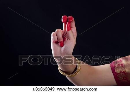 Close-up of a woman's hand making Bharatanatyam gesture on black background View Large Photo Image Stock Photo - Close-up of a woman's hand making Bharatanatyam gesture on black background. Fotosearch