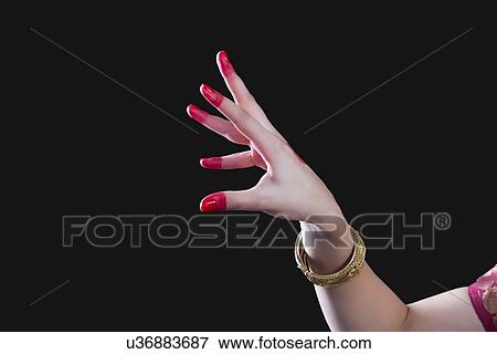 Close-up of a woman's hand making Bharatanatyam gesture called Sandamsha on black background View Large Photo Image Stock Photo - Close-up of a woman's hand making Bharatanatyam gesture called Sandamsha on black background. Fotosearch
