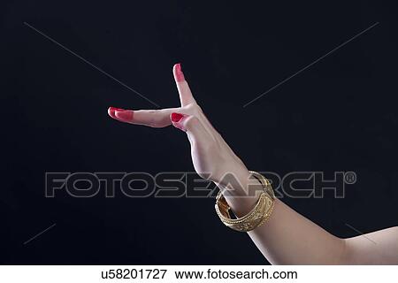 Close-up of a woman's hand making Bharatanatyam gesture called Hamsapaksha on black background View Large Photo Image Stock Photo - Close-up of a woman's hand making Bharatanatyam gesture called Hamsapaksha on black background. Fotosearch