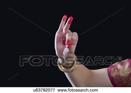 Stock Photo - Close-up of a woman's hand making Bharatanatyam gesture called Bhramara on black background. Fotosearch