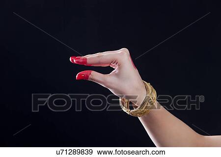 Stock Photo - Close-up of a woman's hand making Bharatanatyam gesture called Padmakosha on black background. Fotosearch