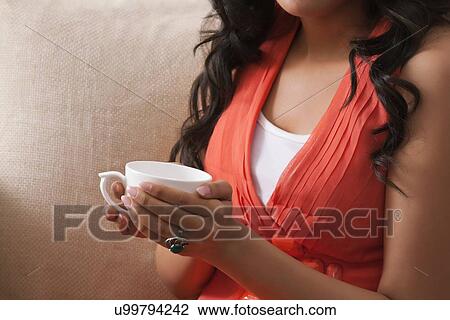 Close-up of a woman's hands holding a coffee cup View Large Photo Image Stock Image - Close-up of a woman's hands holding a coffee cup. Fotosearch
