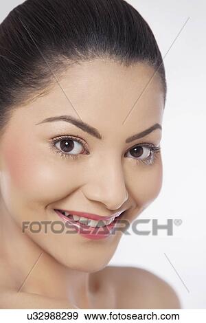 Stock Photo - Close-up of an attractive young woman over white background . Fotosearch