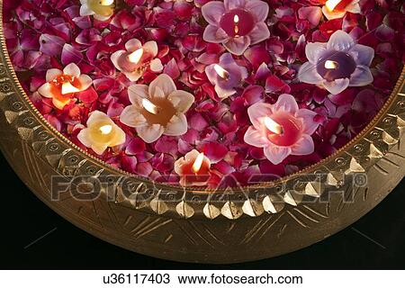 Close-up of an urn with floating diyas View Large Photo Image Stock Image - Close-up of an urn with floating diyas. Fotosearch