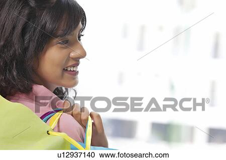 Close-up of beautiful woman shopping happily View Large Photo Image Stock Image - Close-up of beautiful woman shopping happily . Fotosearch