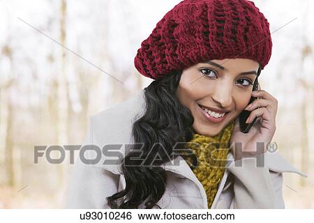 Close-up of beautiful woman talking on cell phone View Large Photo Image Stock Photograph - Close-up of beautiful woman talking on cell phone . Fotosearch