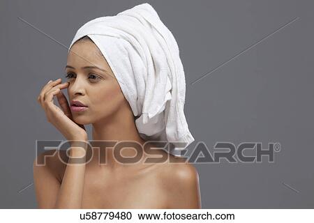 Close-up of beautiful woman touching face View Large Photo Image Stock Image - Close-up of beautiful woman touching face . Fotosearch