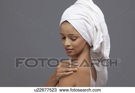 Close-up of beautiful woman with a towel on head View Large Photo Image Stock Image - Close-up of beautiful woman with a towel on head . Fotosearch