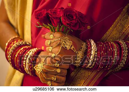 Close-up of Bengali brides hands holding roses View Large Photo Image Stock Photograph - Close-up of Bengali brides hands holding roses . Fotosearch