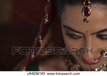 Close up of bindi on beautiful young Indian bride's forehead View Large Photo Image Stock Image - Close up of bindi on beautiful young Indian bride's forehead . Fotosearch