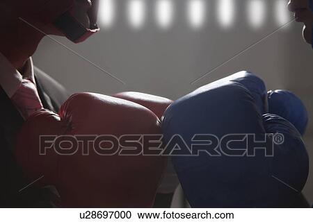 Close-up of boxing gloves worn by businessmen View Large Photo Image Stock Image - Close-up of boxing gloves worn by businessmen . Fotosearch