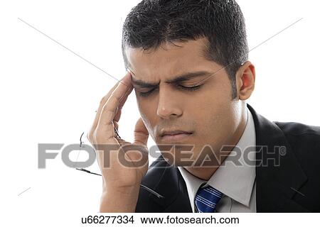Close-up of businessman with headache over white background View Large Photo Image Picture - Close-up of businessman with headache over white background . Fotosearch