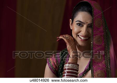 Close-up of cheerful young Indian bride View Large Photo Image Stock Photograph - Close-up of cheerful young Indian bride . Fotosearch