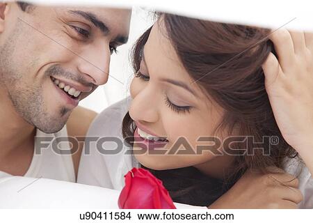 Close-up of couple romancing in bed View Large Photo Image Picture - Close-up of couple romancing in bed. Fotosearch