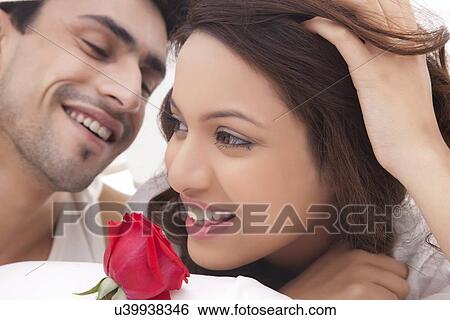 Stock Photograph - Close-up of couple romancing in bed. Fotosearch