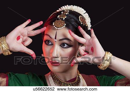 Close-up of furious Bharatanatyam dancer performing on black background View Large Photo Image Stock Image - Close-up of furious Bharatanatyam dancer performing on black background. Fotosearch