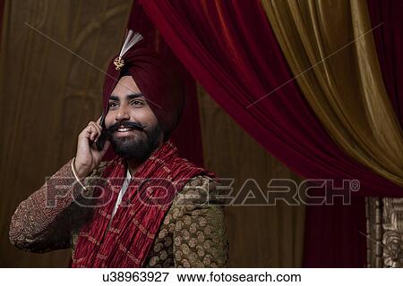 Close-up of groom having conversation on mobile phone View Large Photo Image Stock Photo - Close-up of groom having conversation on mobile phone . Fotosearch