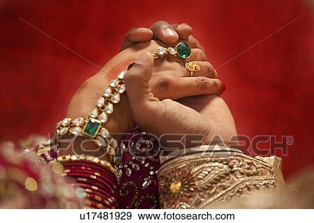 Close-up of groom holding brides hand View Large Photo Image Stock Photo - Close-up of groom holding brides hand . Fotosearch